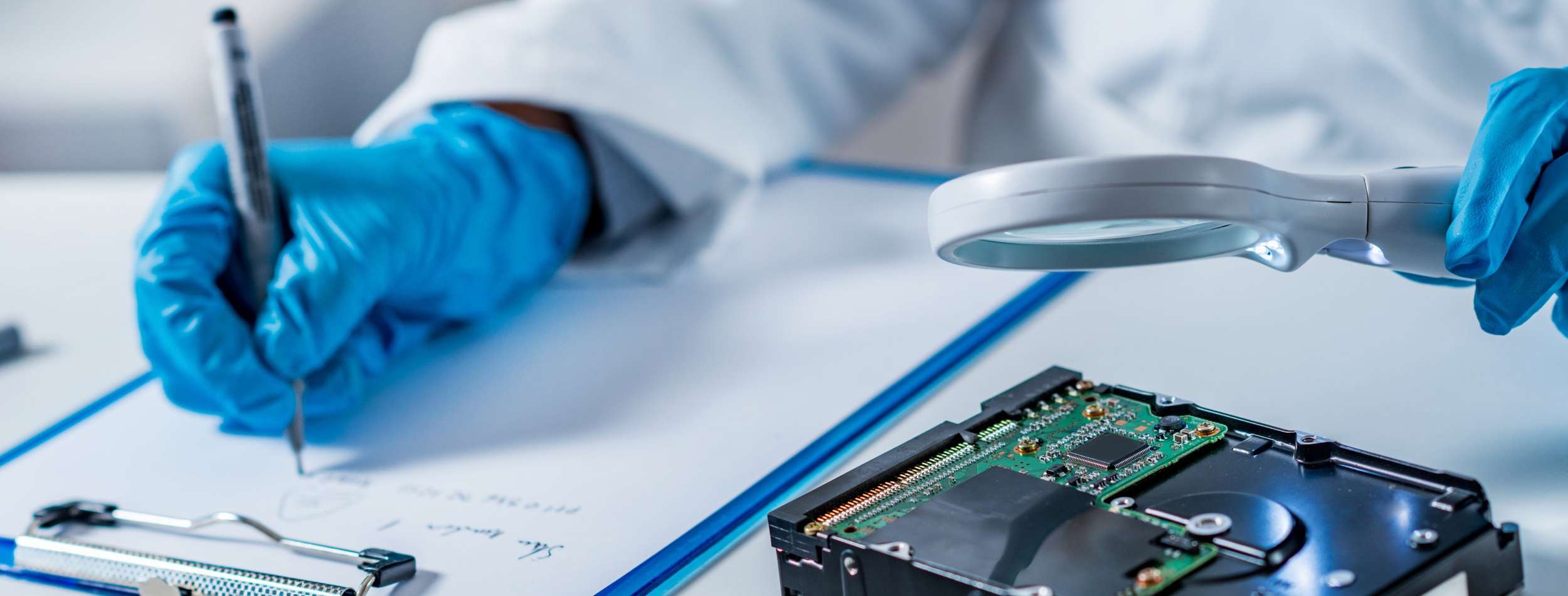 Forensic science expert examining hard drive