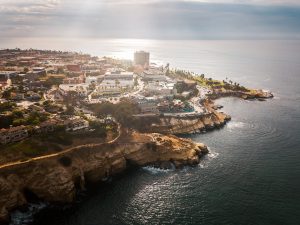 Aerial view of sunny La Jolla village in San Diego California with houses on the cliffs of Pacific ocean