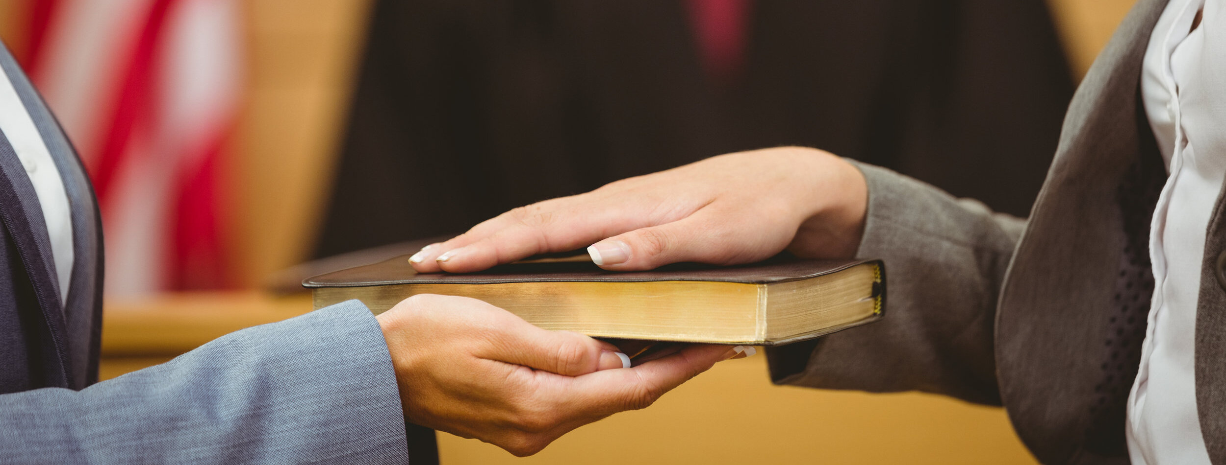 Witness swearing on the bible telling the truth in the court room