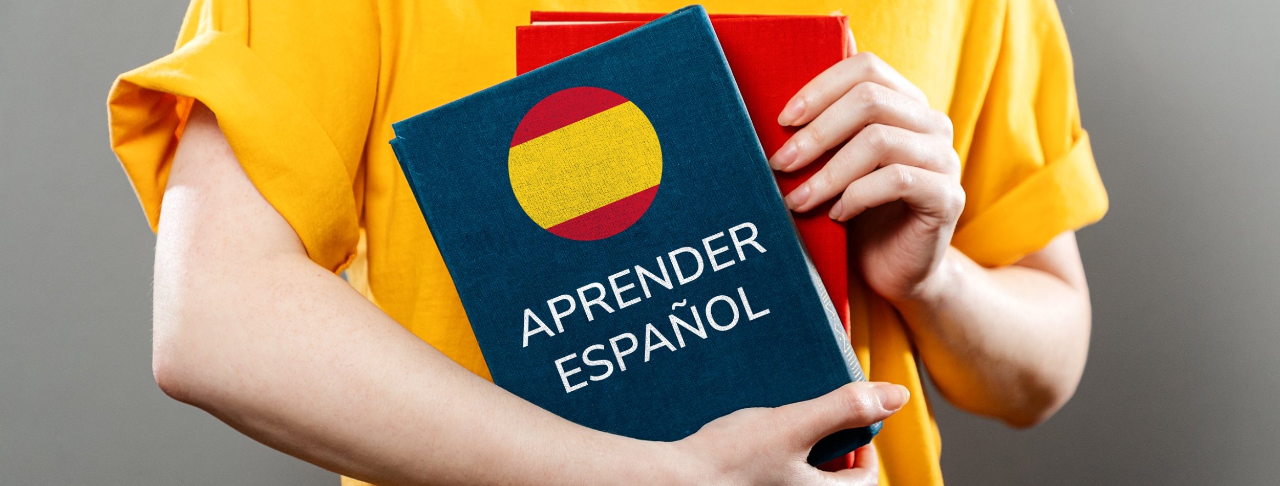 A girl holding some spanish books