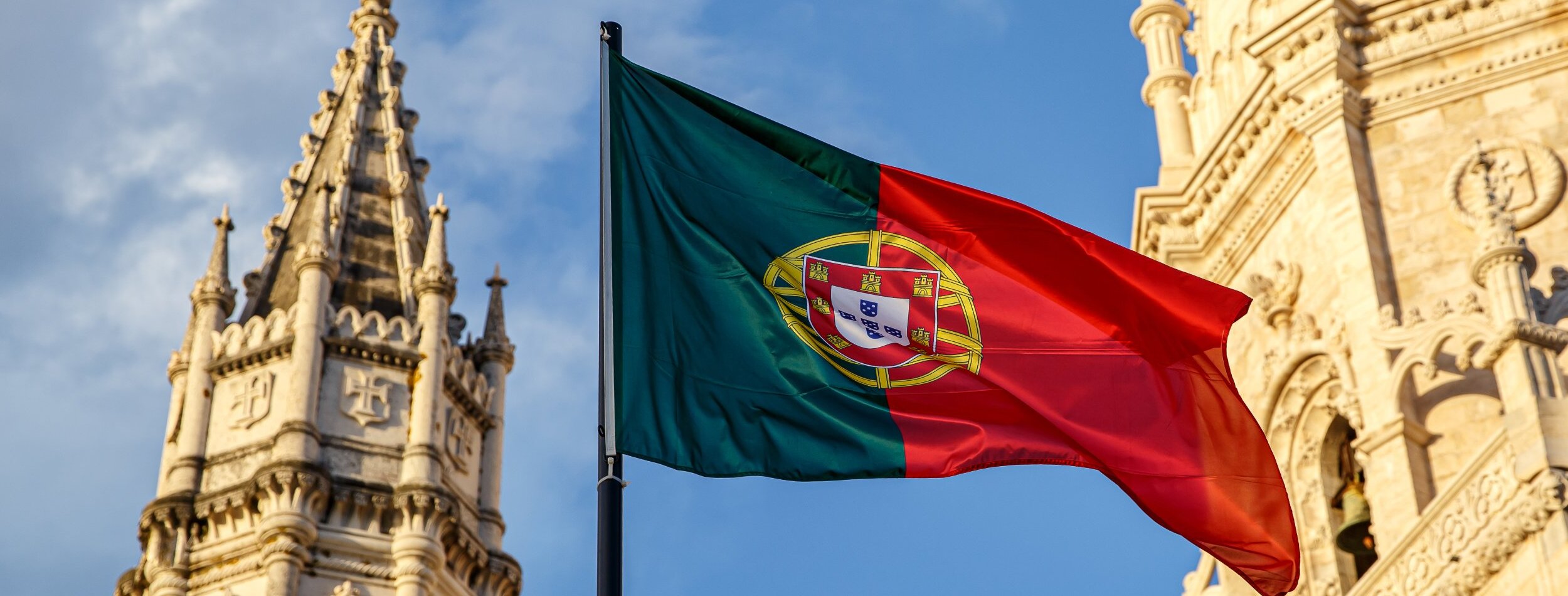 A Portugal Flag in front of a Castle